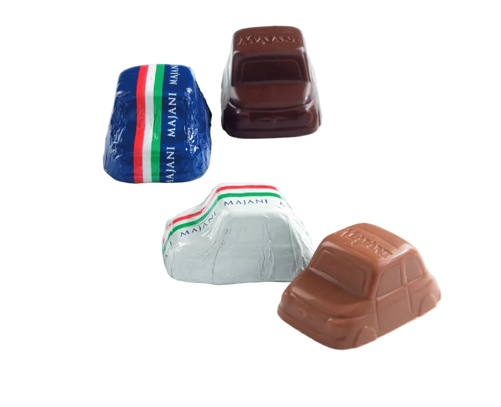 Four car-shaped chocolates on a white background, including two wrapped in blue, white, and silver foil with red and green stripes, and two unwrapped in dark brown and milk chocolate.