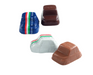 Four car-shaped chocolates on a white background, including two wrapped in blue, white, and silver foil with red and green stripes, and two unwrapped in dark brown and milk chocolate.