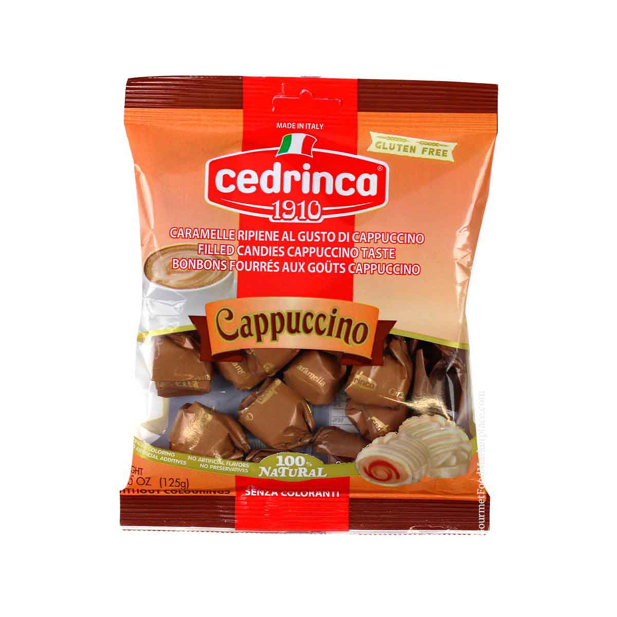 A bag of Cedrinca 1910 Cappuccino flavored filled candies, shown against a plain white background. The packaging is predominantly orange and red with a clear window displaying the brown candy pieces inside.