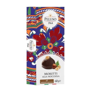 A 2.12 oz box of Peluso Moretti alla Nocciola chocolate, featuring a colorful traditional Italian patterned design with red, blue, and orange motifs, and an illustration of a chocolate nut cookie on the front.